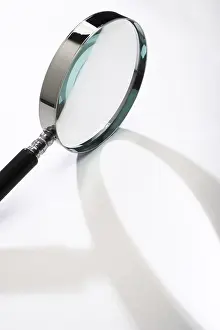 Close Up Concept Image Prints: Magnifying glass casting a shadow