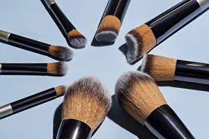 Full Frame Beauty Shot Prints: Make up brushes arranged in a circle on blue background