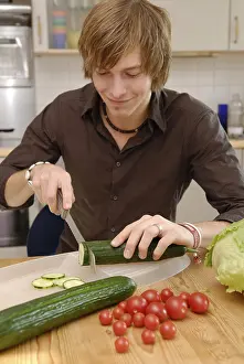 Cucumber Salad Recipe Prints: Man cuts cucumbers