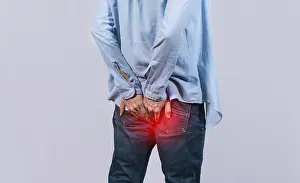 Abdominal Pain Causes Prints: Man with digestive problem touching his buttock