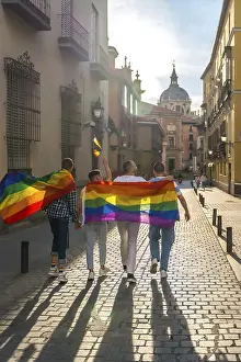 Rainbow Flag Demonstration Prints: Man with his back facing the demonstration with the rainbow flags