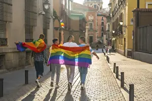 Symbolic Rainbow Picture Prints: Man with his back facing the demonstration with the rainbow flags