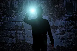 Crime Scene Photography Prints: Man with flashlight in dark urban setting