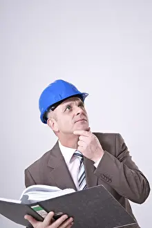 Construction Manager Prints: Man with hard hat and file, thinking