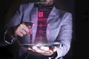 Cybersecurity Threats Prints: A man interacts with a virtual error message related to security on a transparent digital device