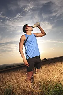 Sportsman In Action Prints: Man jogging through the fields