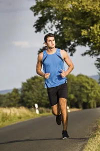 Fitness Man Prints: Man jogging through the fields