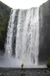 Icelandic Natural Landmarks Prints: Man in front of large waterfall