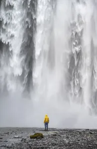 Young Man In Front Of Waterfall Prints: Man in front of large waterfall