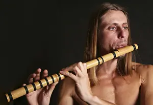 Studio Shot Of Musician Prints: A man playing his wind instrument with expression
