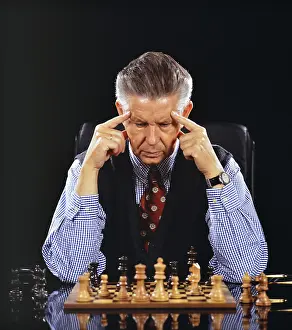 German Studio Shot Prints: A man plays chess and thinks, 60