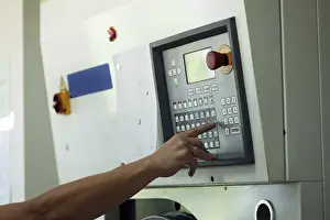 Passenger Traffic Control Prints: Man presses button on electronic control panel
