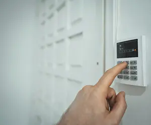 No People In Background Prints: Man putting code in alarm system panel at home