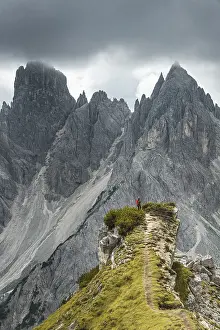 Dolomites Landscape Photography Prints: Man with red jacket standing on one degree