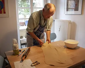 German Food Speciality Prints: Man rolling out strudel dough at a table