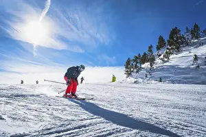 Prints of Man skiing down the ski slope or piste in Pyrenees Mountains. Winter ski holidays in El Tarter, Grandvalira, Andorra Andorra Prints: Man Skiing Down Pyrenees Mountains Print