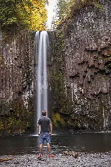 Man In Front Of Waterfall Prints: Man standing in front of a waterfall