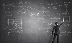 Man In Suit Prints: Man in suit standing with back and drawing formulas on chalkboard