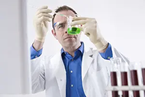Chemistry Experiment Prints: Man working on an experiment in a laboratory
