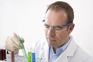 Chemistry Experiment Prints: Man working on an experiment in a laboratory