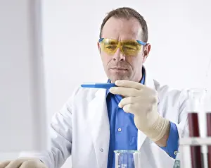 Laboratory Equipment Prints: Man working on an experiment in a laboratory