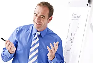 Communication Skills Prints: Manager smiling, standing in front of a flipchart