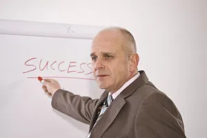 Studio Shot Of A Manager Prints: Manager standing in front of a flip chart
