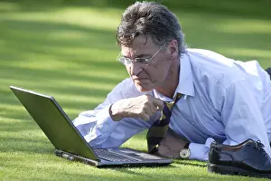 Caucasian Male Professional Prints: Manager working on notebook in parc