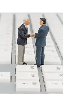 Business Communication Prints: Two managers talking on the keyboard of a computer