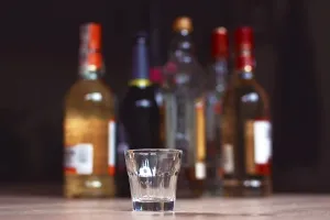 Prints of Mannheim, Germany, June 2019: Empty small shots glass in front of multiple blurry different strong spirits alcohol bottles in dark background Mannheim Prints: Mannheim, Germany Print: Blurred Spirits Bottles