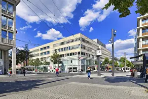 Prints of Mannheim, Germany, September 2020: Street called Planken in city center of Mannheim with people strolling by and passing cable cars on sunny day Mannheim Prints: Mannheim, Germany Print: Planken Street Scene