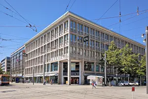 Prints of Mannheim, Germany - May 9th 2026: Large modern C&A clothing store building at Paradeplatz in Mannheim on sunny day with blue sky Mannheim Mannheim Prints: Mannheim, Germany - Print of Modern C&A Store at Paradeplatz
