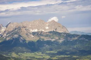 Cloudy Mountain Scenery Prints: Massive mountain range under dramatic cloud formations and dense forest