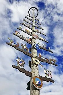 Southern Germany Landscapes Prints: Maypole with guild sign in front of cloud sky
