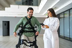 Modern Healthcare System Prints: Mechanical exoskeleton, female doctor physiotherapist with disabled person with robotic skeleton in rehabilitation