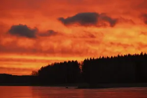 Frozen Scandinavian Landscape Prints: A dramatic sunset over a still