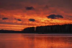 Atmospheric Evening Light In Nature Prints: A dramatic sunset over a still