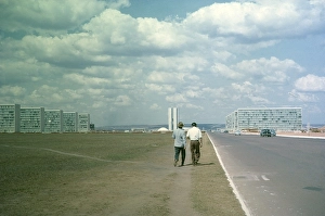 Historic City Center Brazil Prints: Two men walking along a nondescript road next to cars