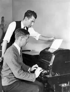 Vintage Typewriter Prints: Two men working on a typewriter