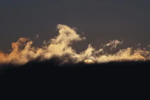 Serene Evening Sky Prints: A mesmerizing sunset with dramatic cloud formations and a serene sky