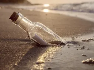 Atmospheric Evening Light Photography Prints: Message in the bottle washed ashore against the Sun setting down