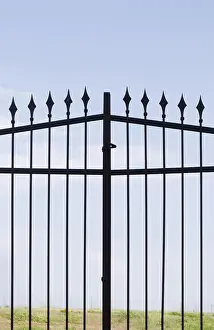 Abandoned Entrance Gate Prints: A metal gate with sharp spears