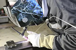 Construction Equipment Use Prints: Metal worker during welding work