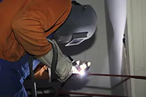 Industrial Equipment Prints: Metal worker during welding work