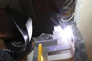 Industrial Workplace Safety Prints: Metal worker during welding work