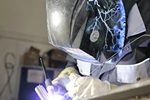 Industrial Equipment Prints: Metalworker during welding work in his workshop