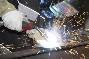 Manual Labor Prints: Metalworker during welding work in his workshop