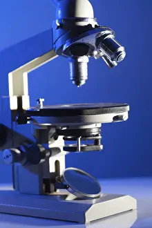 Laboratory Equipment Prints: Microscope on the table in laboratory with blue light