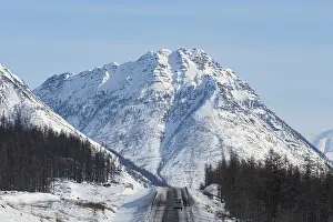 Uninhabited Mountain Ranges Prints: Minivan driving on the Road of Bones