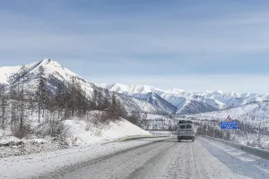 Deserted Mountain Highway Prints: Minivan driving on the Road of Bones